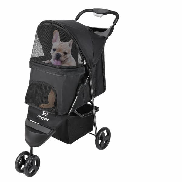 Black pet stroller with a dog inside on a white background