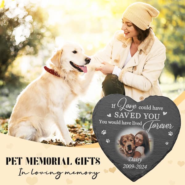 Woman sitting with a dog in a park, next to a pet memorial gift heart-shaped plaque.