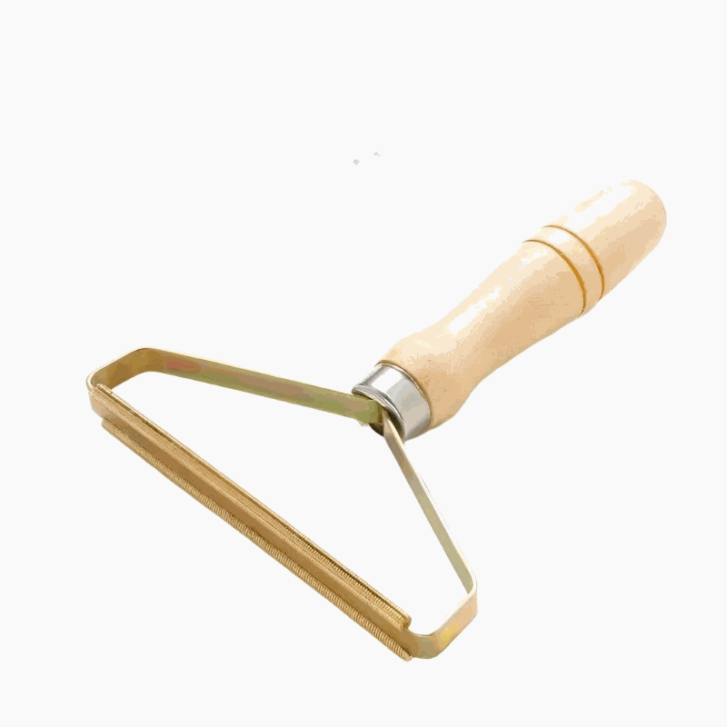Portable lint remover scraping pet hair from a wool coat, reusable manual cleaning tool for carpets, clothes, and upholstery.