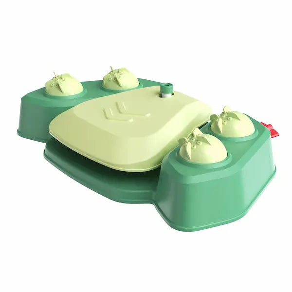 Large dog playing with green step-on sprinkler toy outdoors in summer