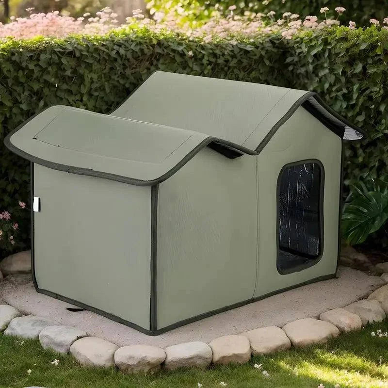 Waterproof outdoor cat house with removable roof placed in garden.