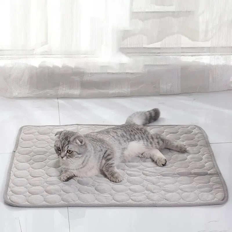 Cooling Pet Ice Mat – Lightweight summer bed for cats and small dogs in blue and grey. Soft, breathable material. Available in two sizes.