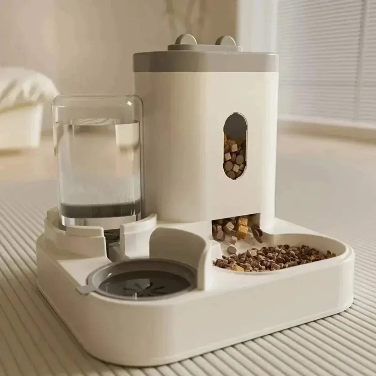 Automatic pet feeder with water fountain and large capacity food storage for dogs and cats.