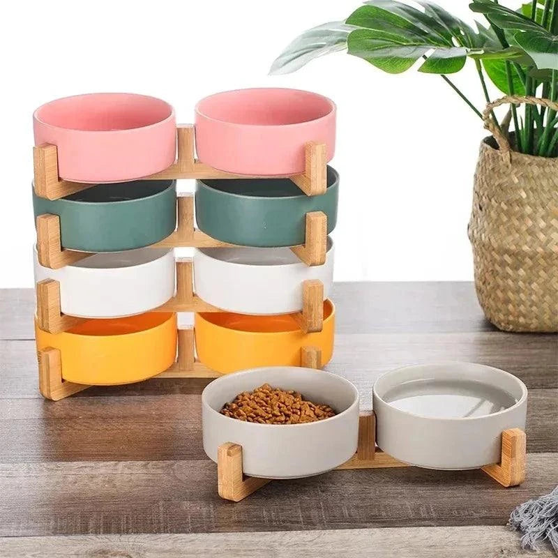 Ceramic pet bowl with wood stand, ideal for dog or cat food and water.