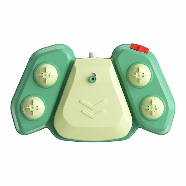 Large dog playing with green step-on sprinkler toy outdoors in summer