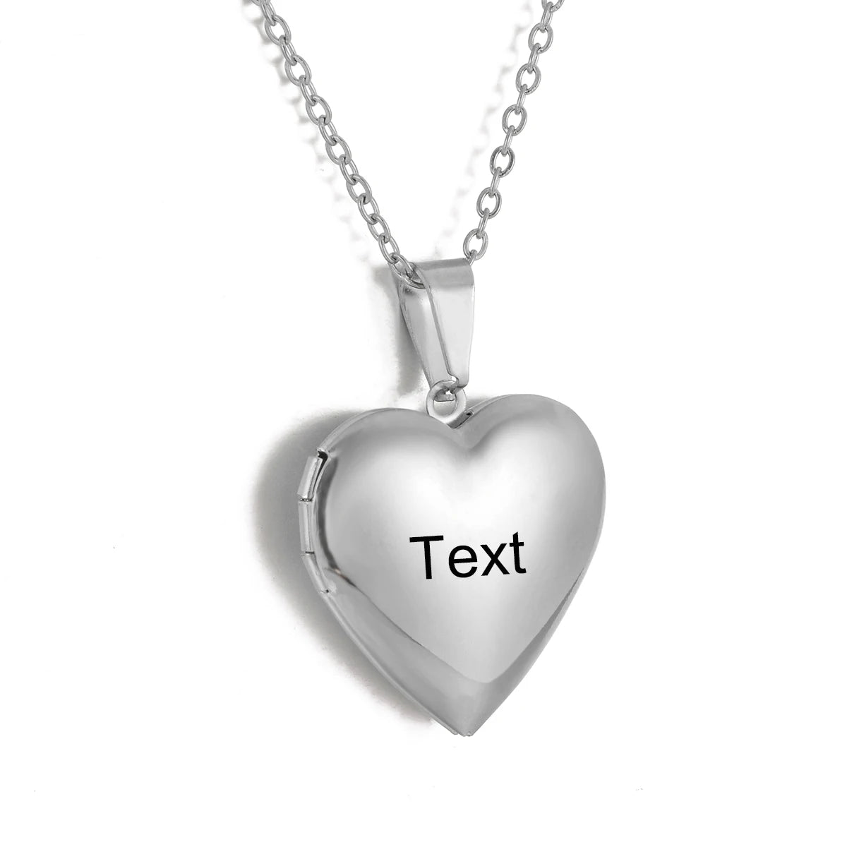 Silver heart-shaped locket with 'Text' engraving on a white background