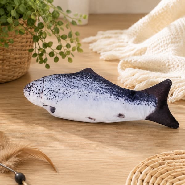 Realistic salmon plush cat toy resting on a wooden floor in a cozy indoor setting for cats and kittens