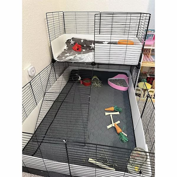 Pet cage with bedding, toys, and a water bottle inside