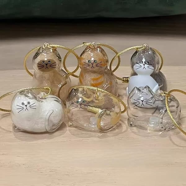 A transparent cat-shaped keychain designed to hold a small lock of fur or whisker, perfect as a memorial keepsake for cat lovers.