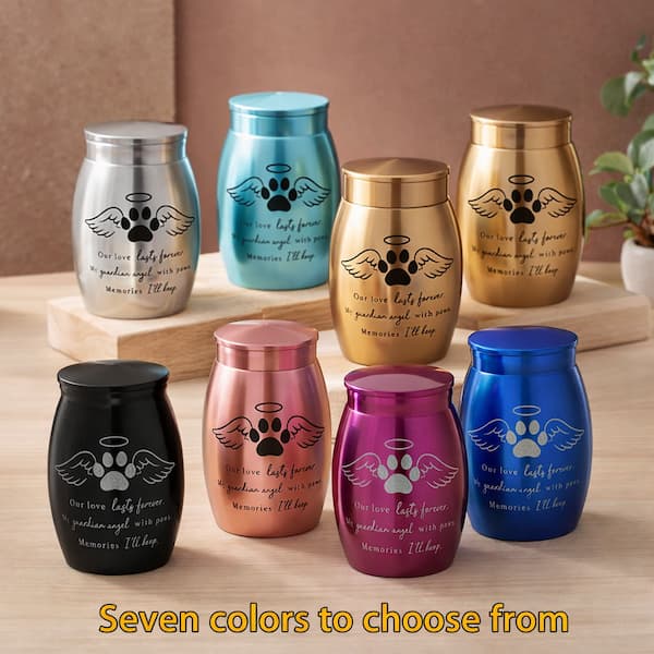 Set of colorful urns with paw prints and angel wings on a wooden surface.