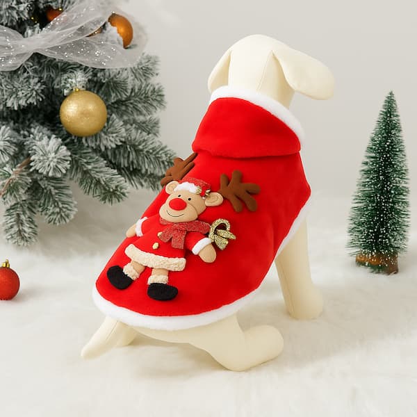 Doggy Christmas outfit with red and white design, placed on a fluffy surface with a Christmas tree in the background.