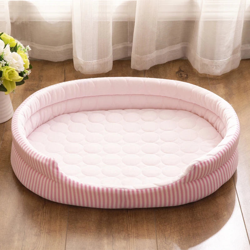 Pink cooling pet bed with striped pattern on a wooden floor