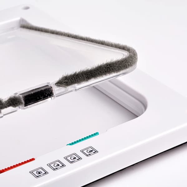 Close-up of a test strip with a dropper and a testing device for a pet door on a white background