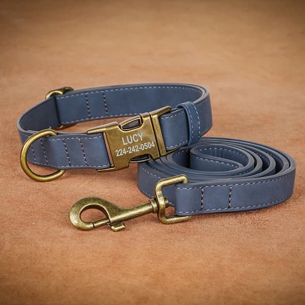 Blue dog collar and leash set with brass hardware on a brown background