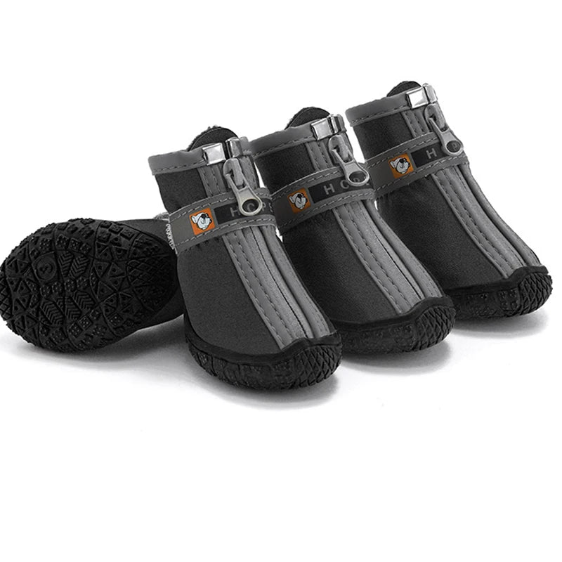 Set of four gray and black dog boots on a white background