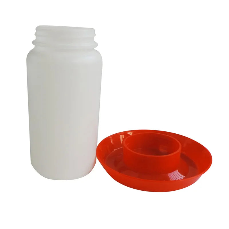 White plastic bottle and red plastic feeder on a white background