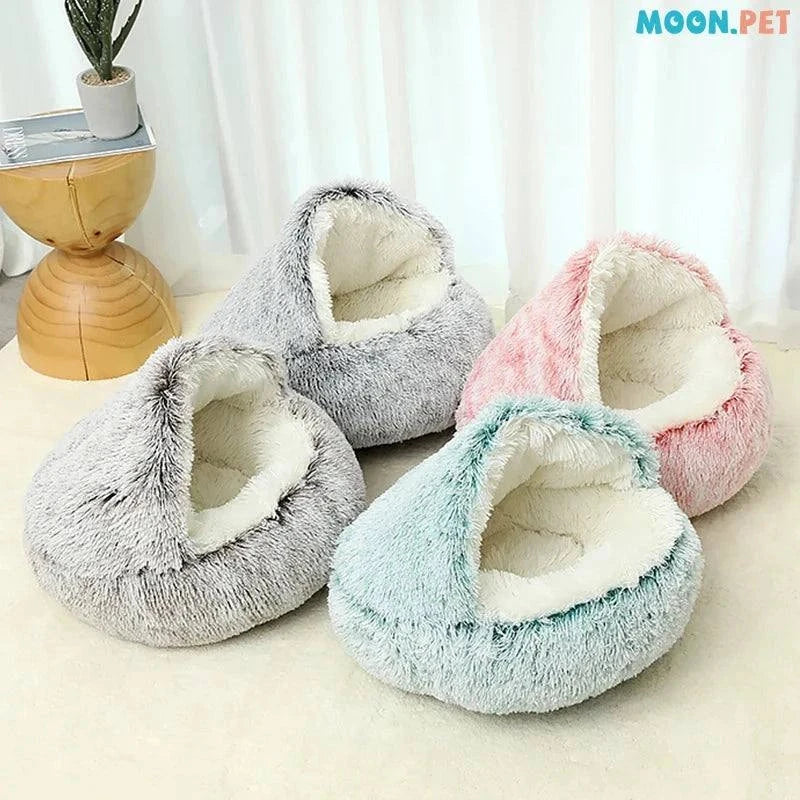 Cozy plush pet bed with a cat nestled inside, designed for small dogs and cats, featuring a soft, round sleeping nest with a cave-style opening.