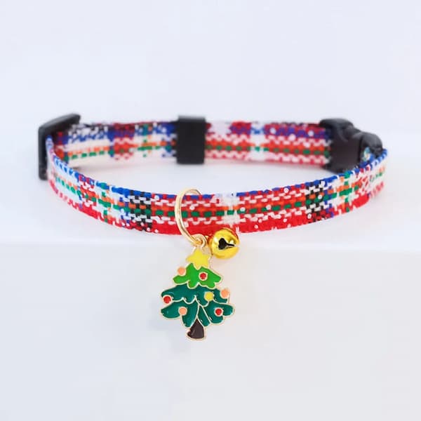 Colorful dog collar with a Christmas tree charm on a white background