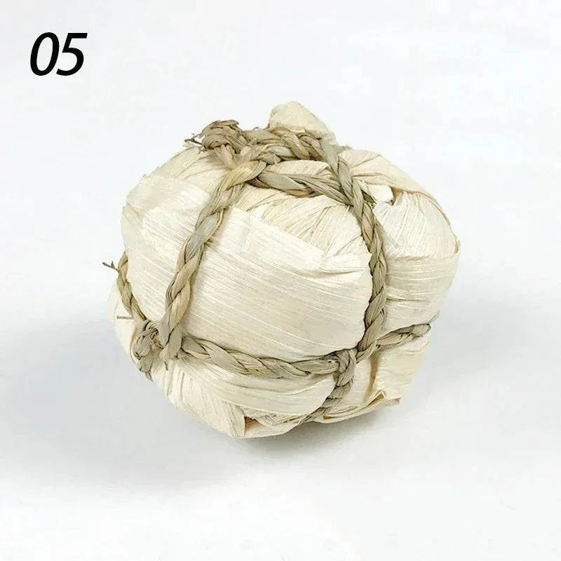 Braided natural grass chew ball for small pets, 7cm toy for guinea pigs, rabbits, and hamsters.