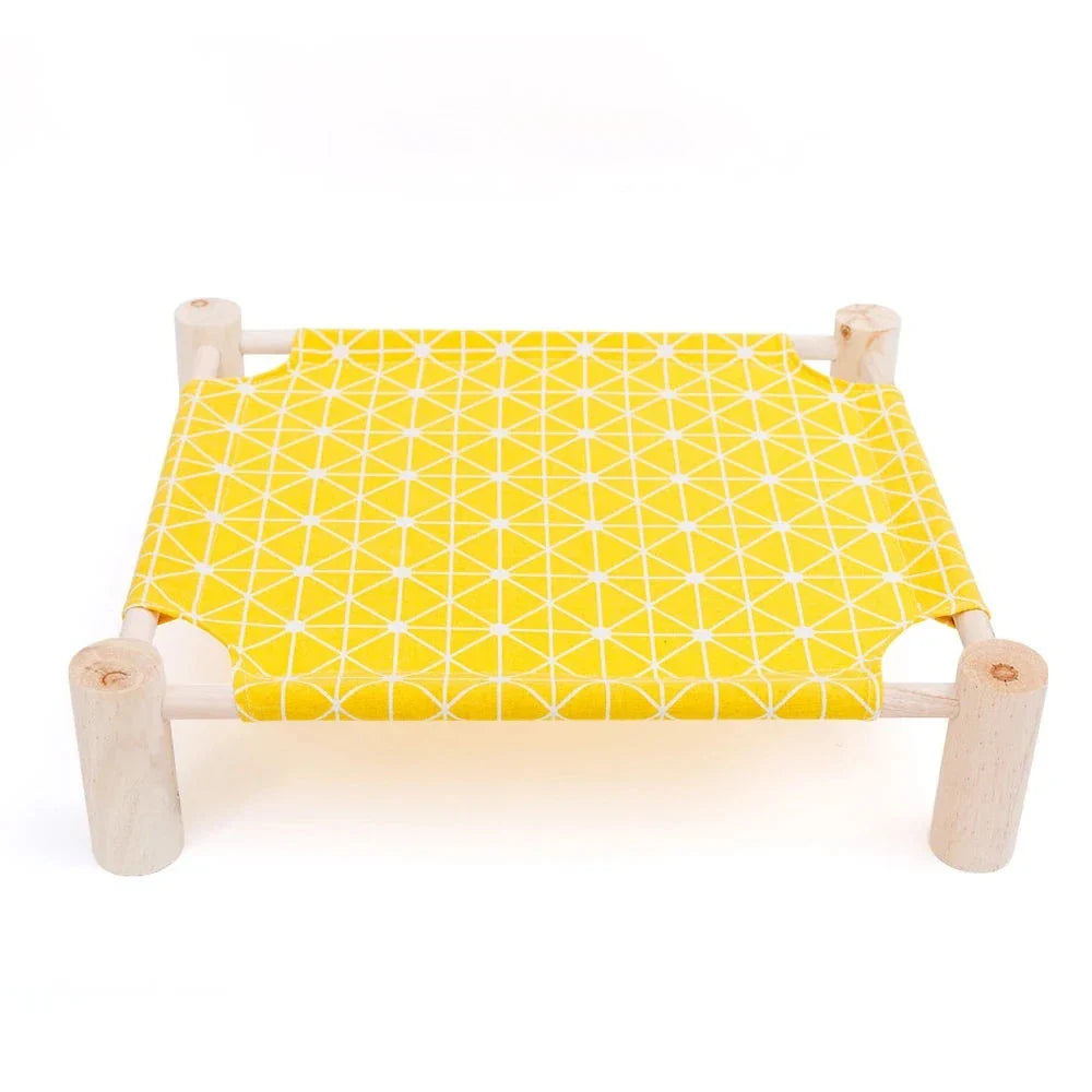 Modern wooden raised cat bed with yellow geometric fabric cushion, stylish pet furniture.