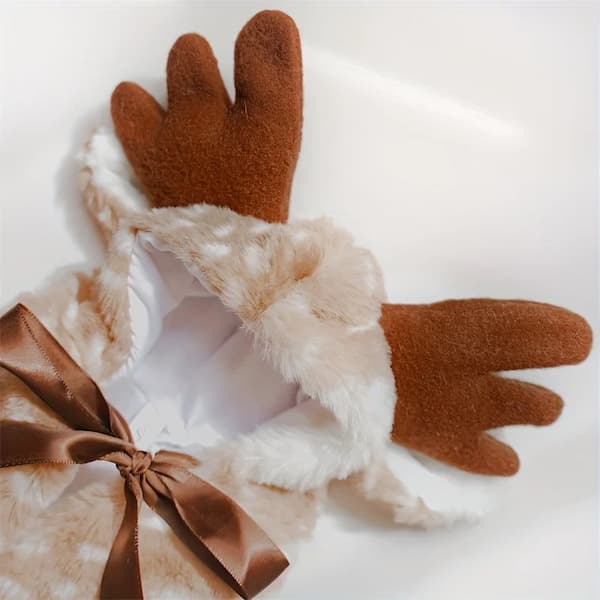 Pair of brown and white reindeer antlers with a bow on a light background