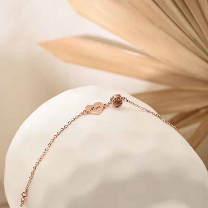 Rose gold bracelet on a white stand with a soft beige background