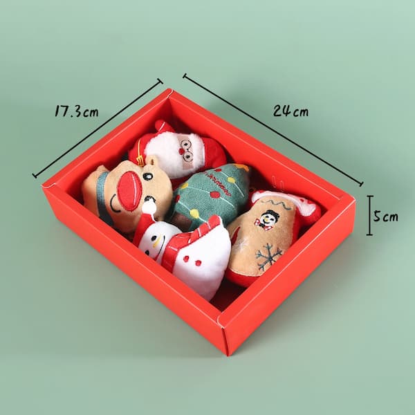 Set of Christmas-themed ornaments in a red box with dimensions on a green background