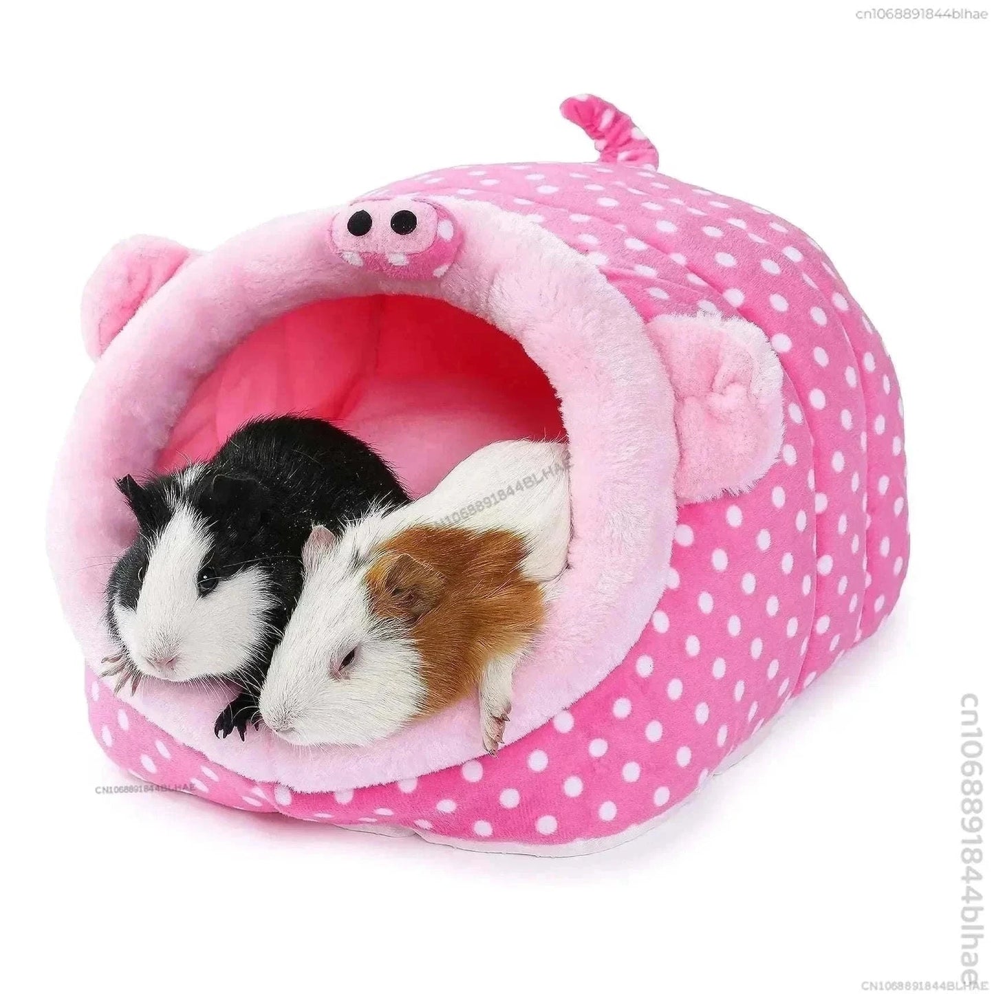 Pink polka dot pet house for small animals with guinea pigs inside.