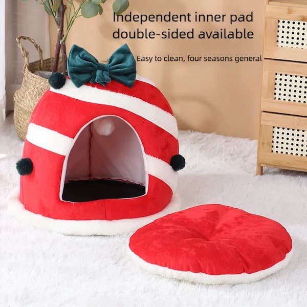 Red pet bed with a green bow and matching round cushion on a light background