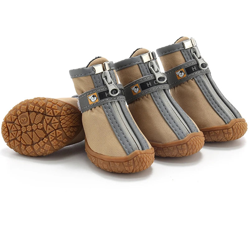 Pair of beige and gray dog boots with brown soles on a white background