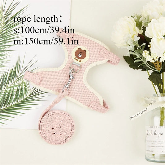 Pink dog harness with a bear design on a white surface with text indicating rope length.