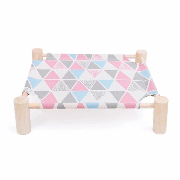 Small wooden bed with geometric patterned blanket on a white background