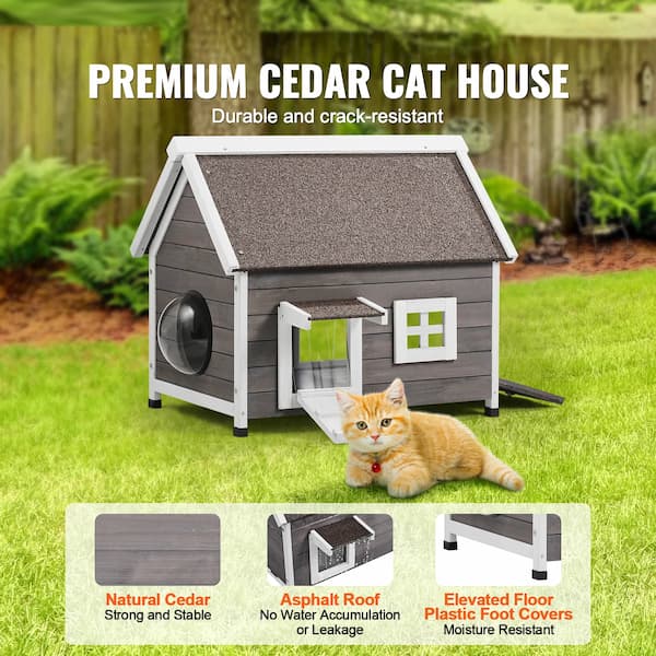 Premium cedar outdoor cat house with asphalt roof and escape door placed on grass – weatherproof wooden shelter for feral and outdoor cats.