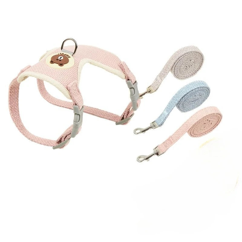 Pink dog harness and leash set with bear design on a white background