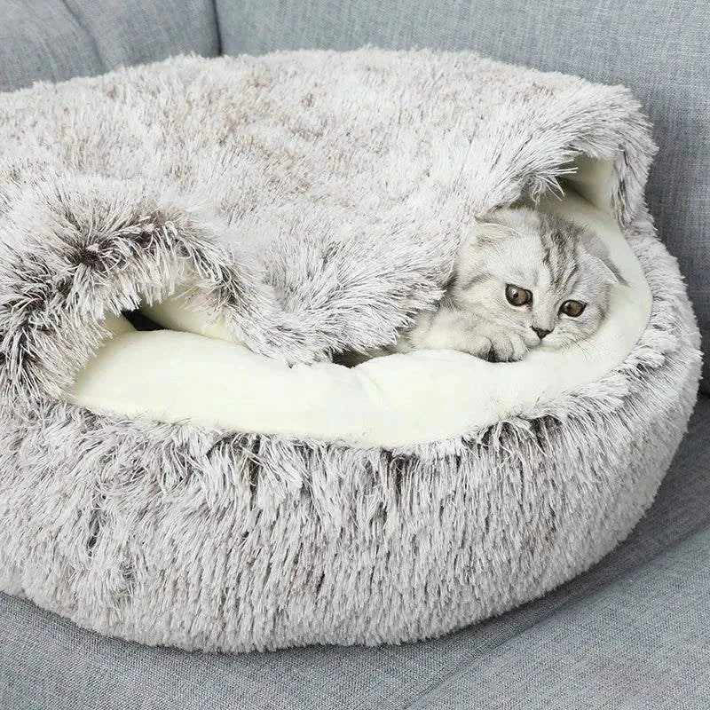 Cozy plush pet bed with a cat nestled inside, designed for small dogs and cats, featuring a soft, round sleeping nest with a cave-style opening.