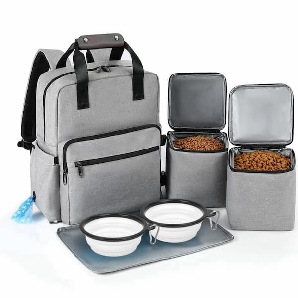 Gray pet travel backpack with food containers and bowls on a white background