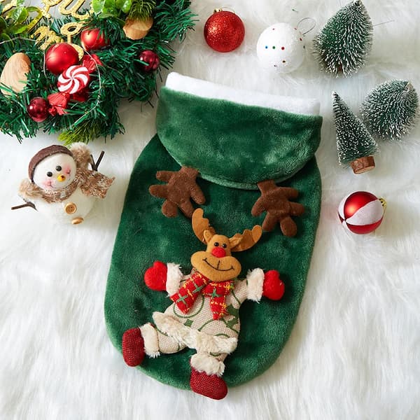 Green Christmas pet hoodie with a reindeer design surrounded by festive decorations on a white surface.