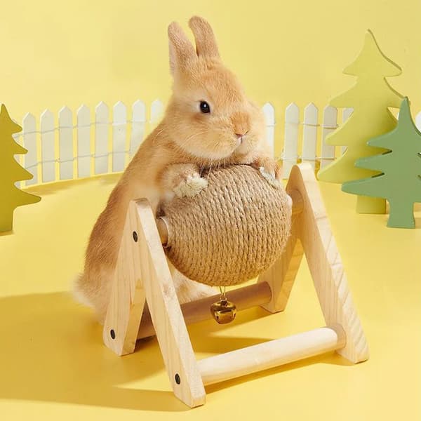 Small rabbit on a wooden stand with a ball, against a yellow background with decorative trees.