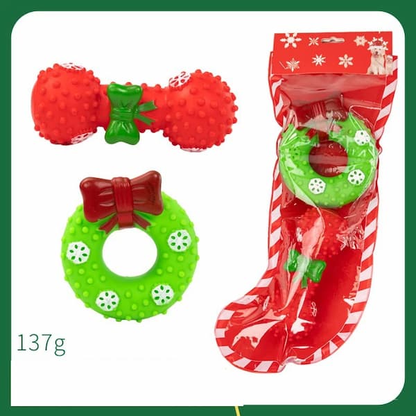 Red and green dog toys with a stocking packaging on a white background