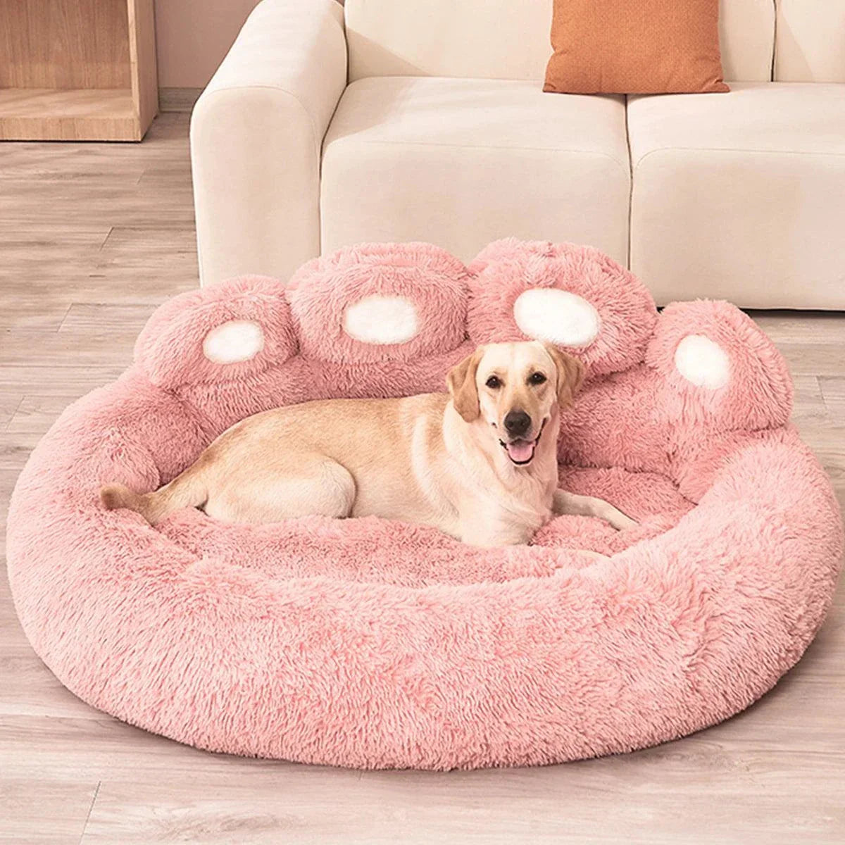 Large pink fluffy dog bed providing cozy support for a pet, ideal for dogs and cats.