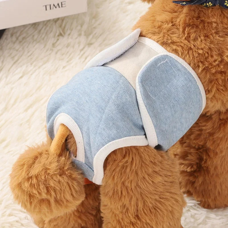 Reusable female dog diaper pants in soft fabric, shown on a small dog. Washable pet shorts designed for comfort and hygiene.
