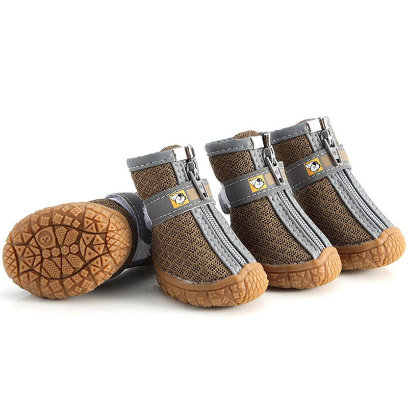 Four brown and gray pet boots with textured soles on a white background
