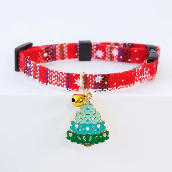 Red patterned cat collar with a Christmas tree charm on a white background
