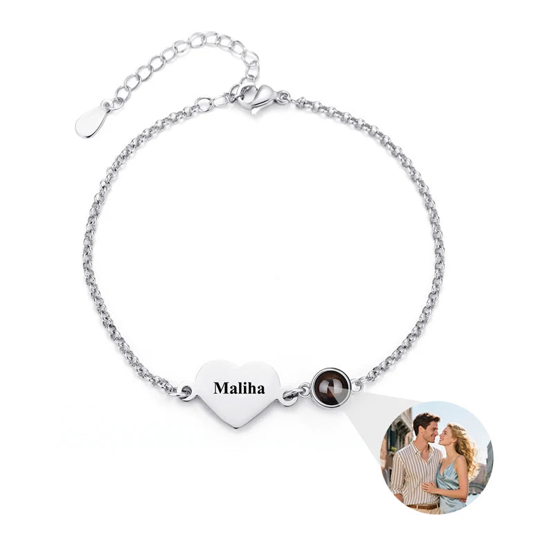 Silver bracelet with heart-shaped charm featuring a name and photo on a white background