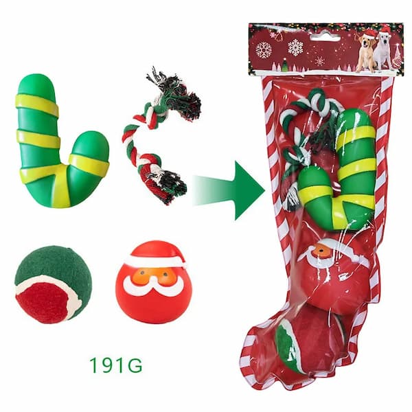 Collection of Christmas-themed dog toys including a stocking, candy canes, and Santa face ball on a white background.
