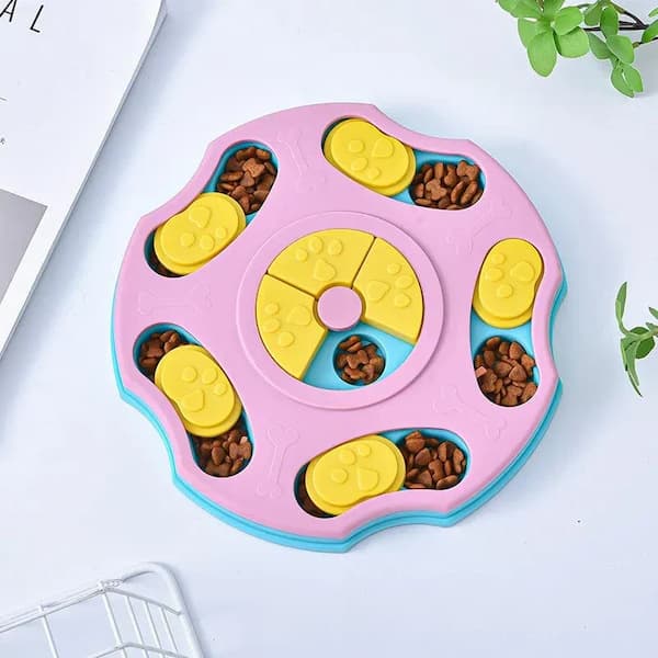 Pink and blue dog puzzle toy with compartments filled with treats on a light background