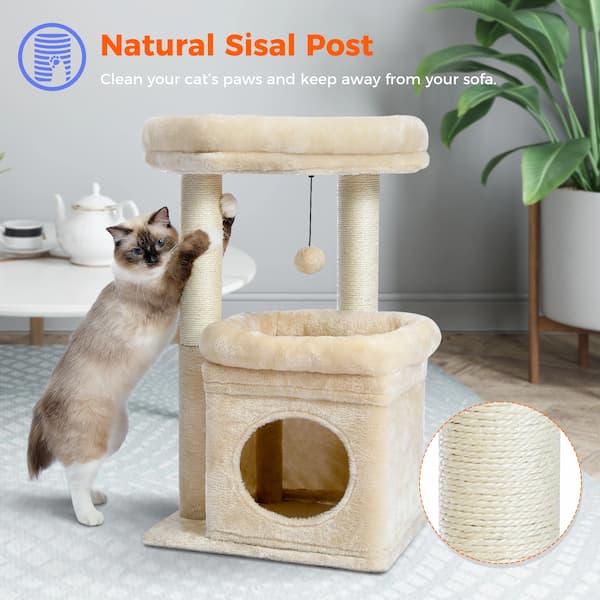 Cat playing with a beige cat tree with sisal post in a home setting