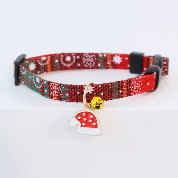 Red and green patterned cat collar with a mushroom-shaped charm on a white background