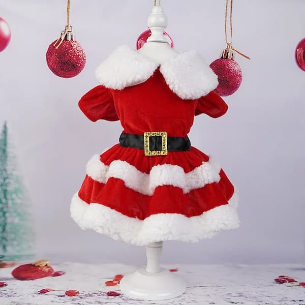 Red and white Santa Claus dress on a mannequin with Christmas decorations in the background.