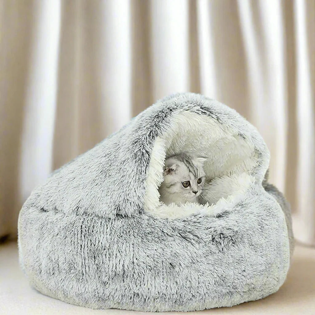 Cozy plush pet bed with a cat nestled inside, designed for small dogs and cats, featuring a soft, round sleeping nest with a cave-style opening.